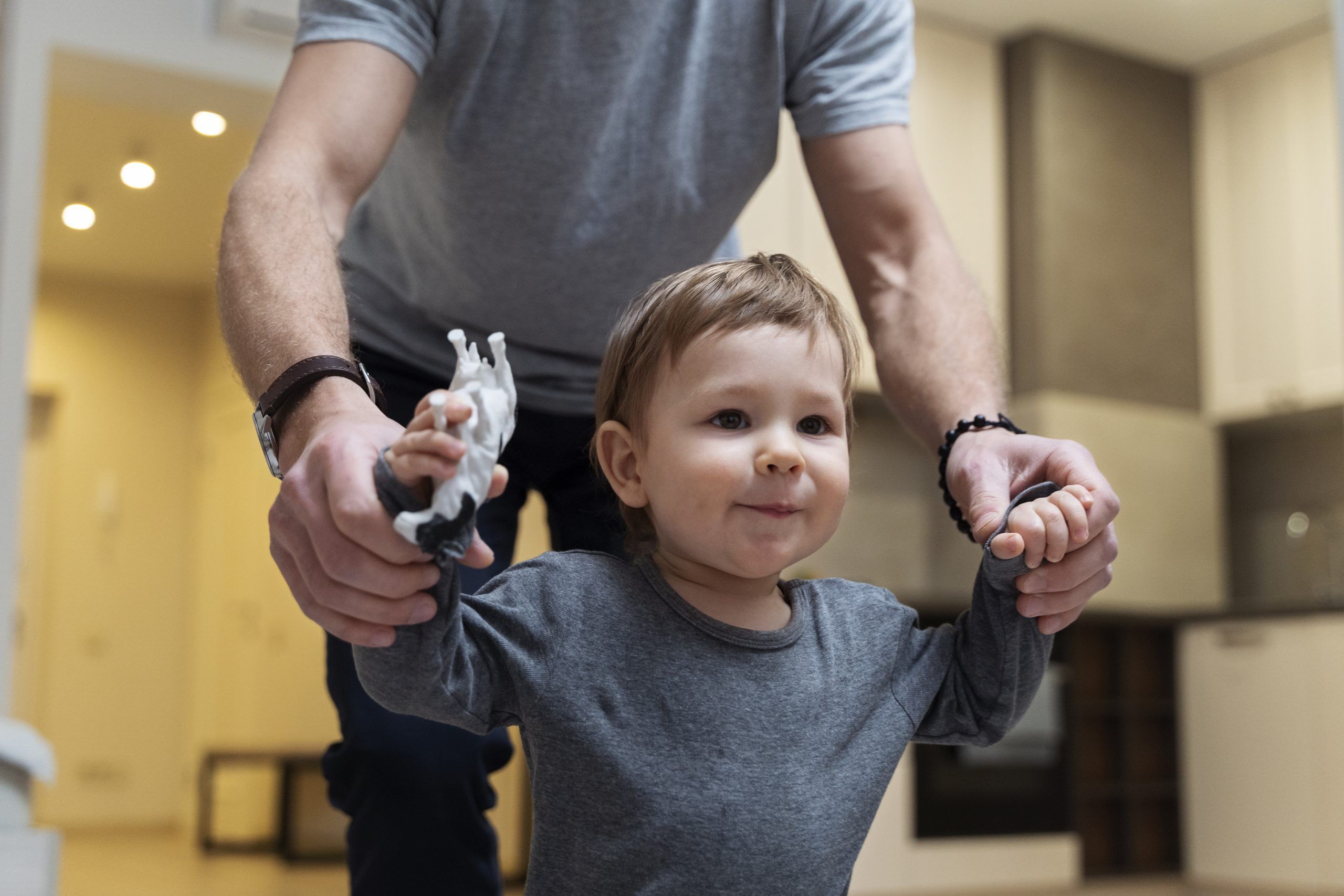 cute-kid-walking-indoors-with-father